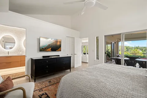 a bedroom with furniture and a flat screen tv