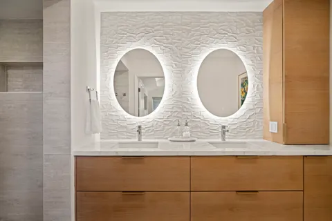 a bathroom with a mirror and a sink