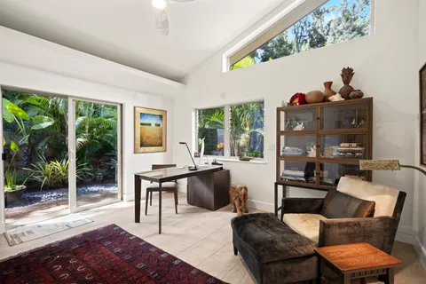 a living room with furniture and a floor to ceiling window