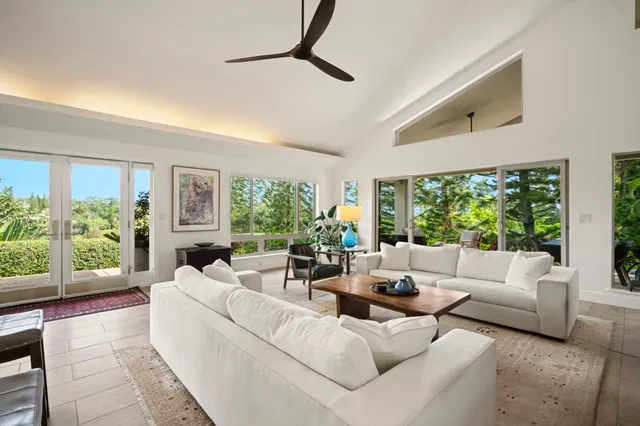 a living room with furniture and kitchen view
