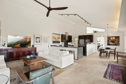 a living room with furniture and kitchen view