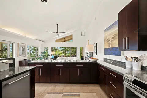 a kitchen with a sink and a stove top oven