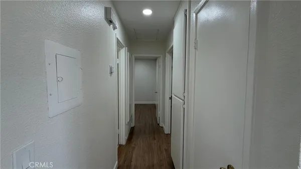 a view of a hallway with wooden floor