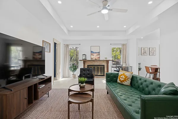 a living room with furniture flat screen tv and a fireplace