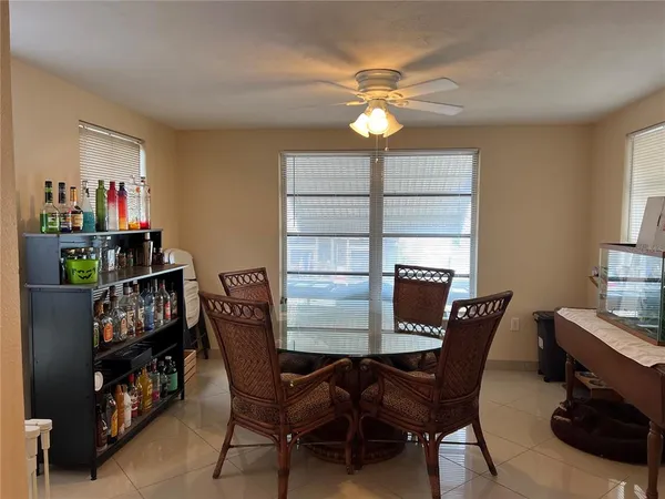 a view of a dining room with furniture and a window