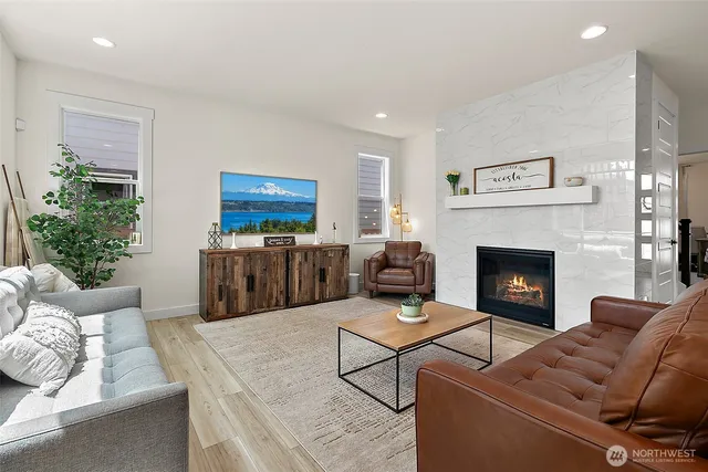 a kitchen with stainless steel appliances a dining table chairs sink and cabinets