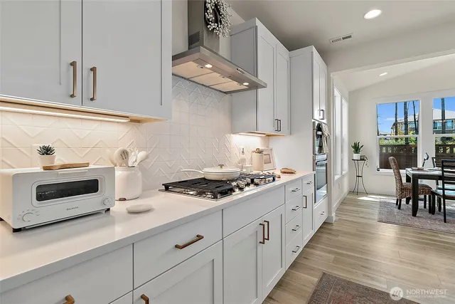a kitchen with counter top space a sink and appliances