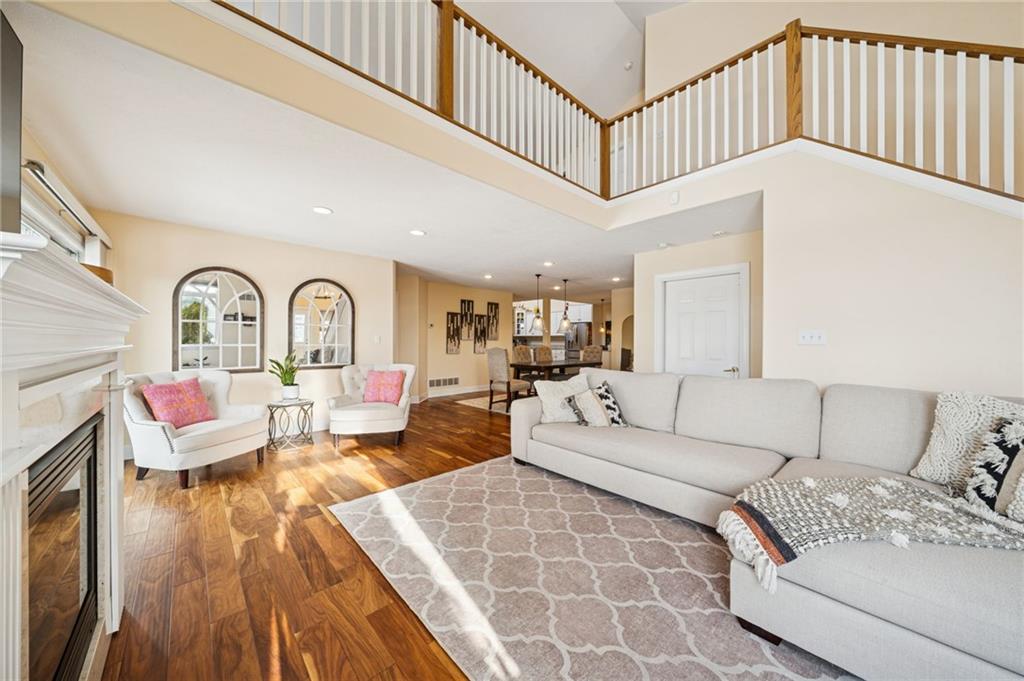 424 Scarletview Court Monroeville, PA 15146 - Photo 2 of 47 Large 27X14 living room with beautiful engineered hard wood floors, tons of natural light and a cozy gas fireplace