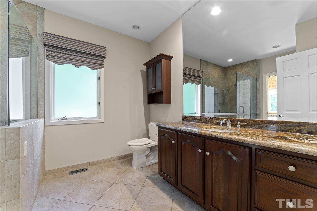 2008 Prescott Place Raleigh, NC 27615 - Photo 23 of 30 a bathroom with a granite countertop sink toilet and mirror