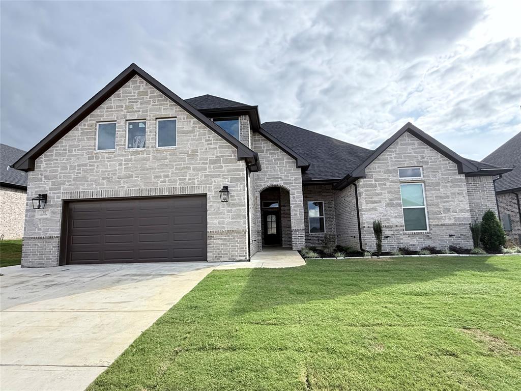 192 Lakeview Circle Pilot Point, TX 76258 - Photo 1 of 1 a front view of house with yard and green space