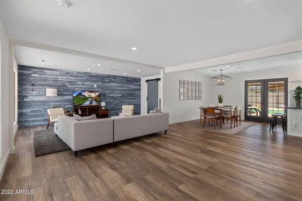 a living room with furniture and wooden floor