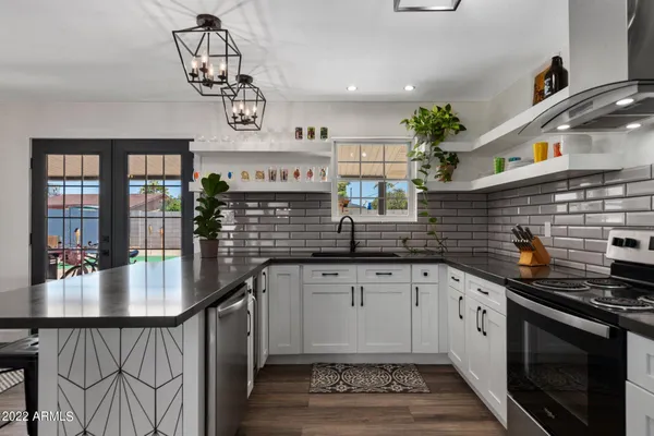 a kitchen with granite countertop a stove a sink and a cabinets