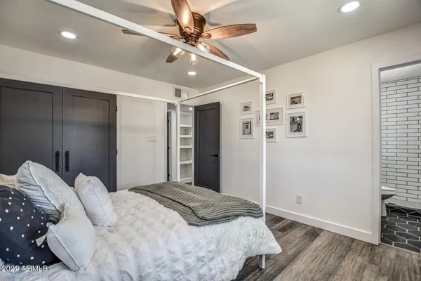 a bedroom with a large bed and a ceiling fan