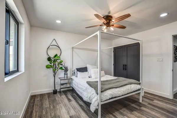 a bedroom with a bed and a ceiling fan