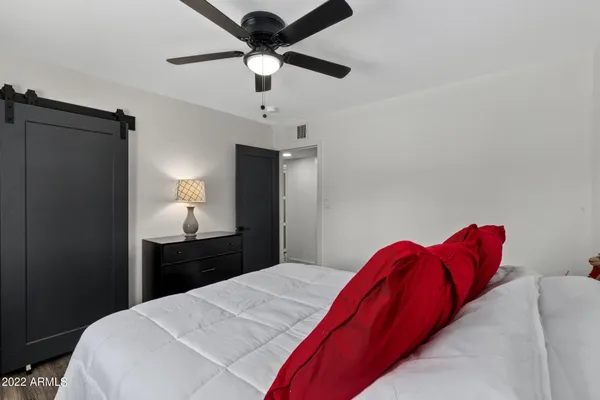 a bedroom with a bed and a chandelier