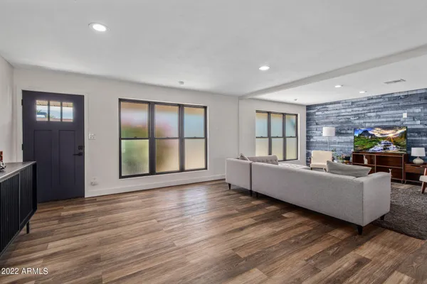 a living room with furniture and large windows