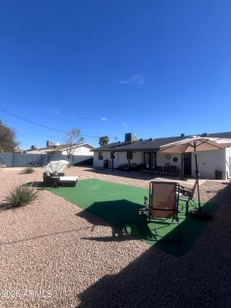 a view of a yard with table and chairs