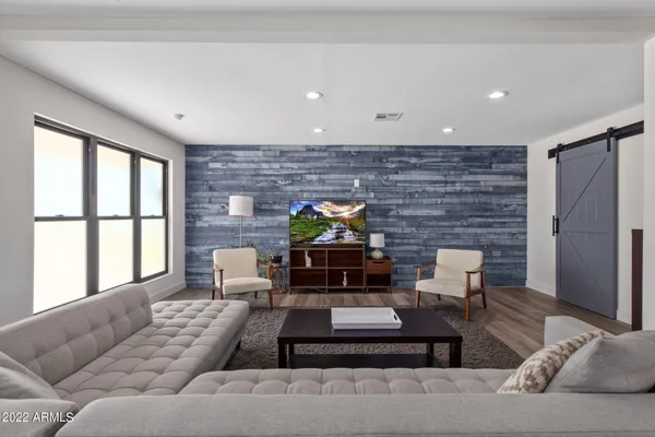 a living room with furniture wooden floor and a fireplace