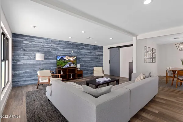 a living room with furniture and wooden floor