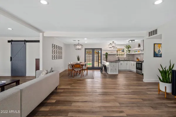a living room with furniture and wooden floor