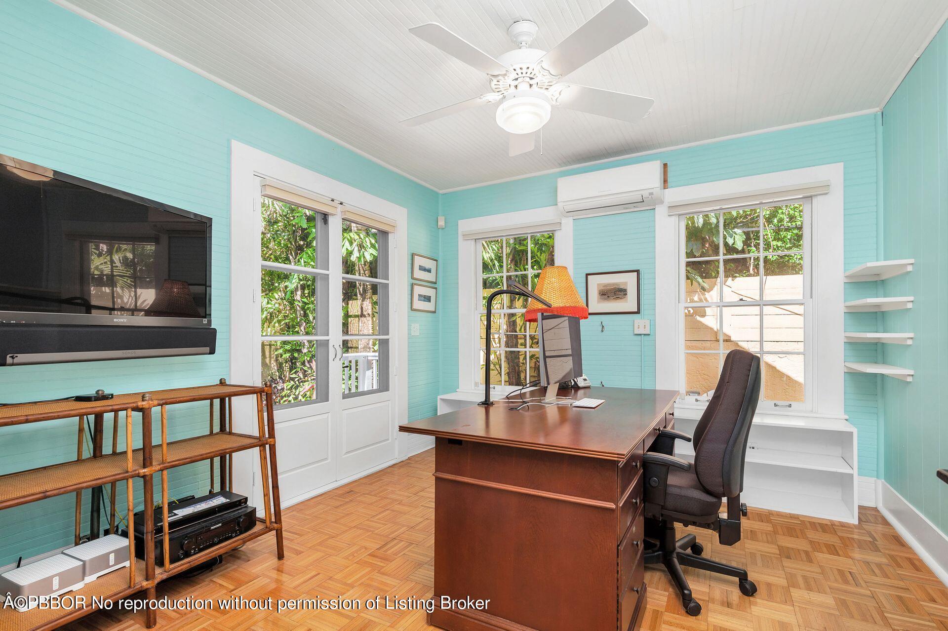 138 Root Trail Palm Beach, FL 33480 - Photo 11 of 23 a dining room with furniture a flat screen tv and a floor to ceiling window