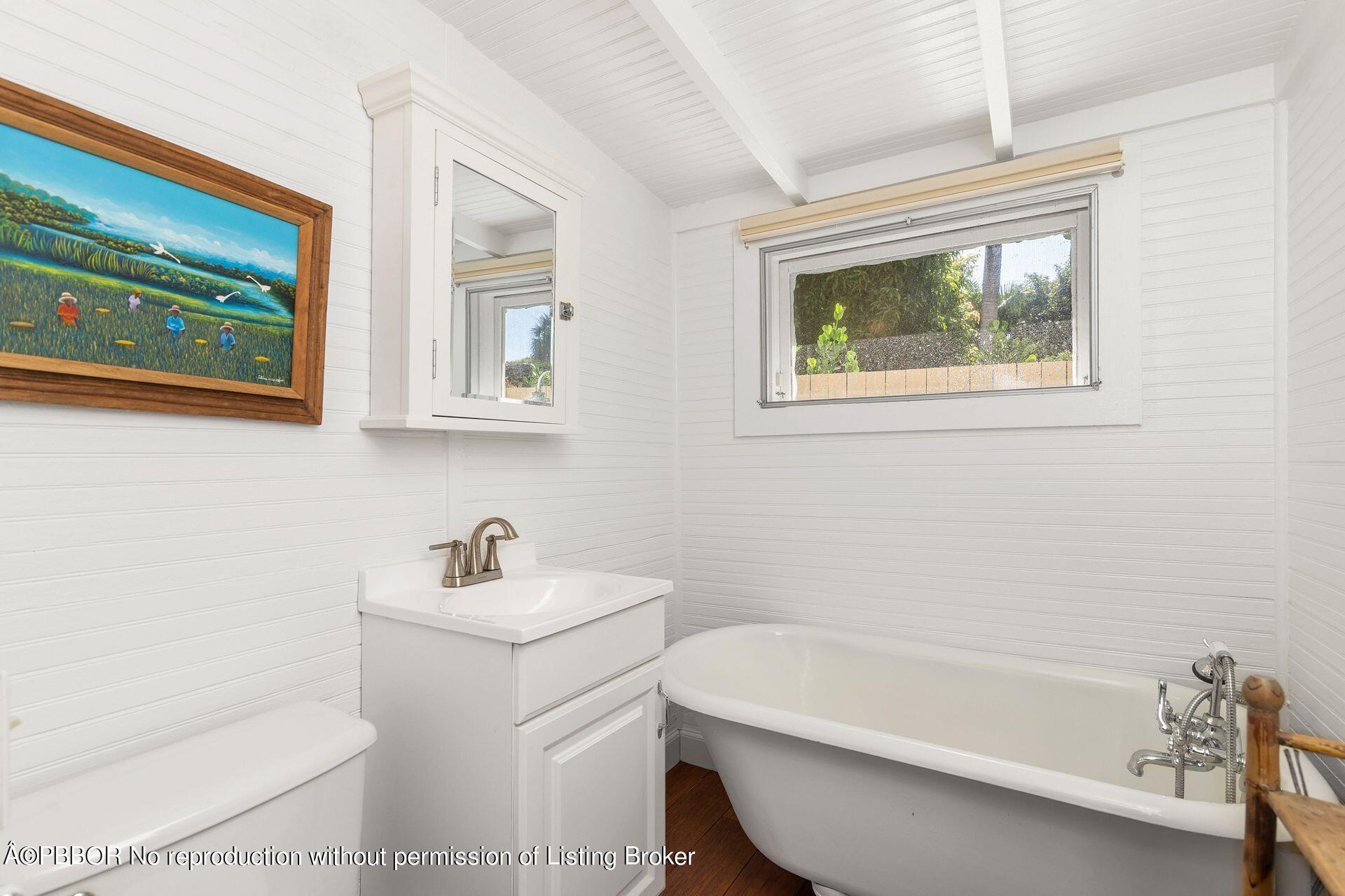 138 Root Trail Palm Beach, FL 33480 - Photo 12 of 23 a bathroom with a sink a toilet and a bathtub