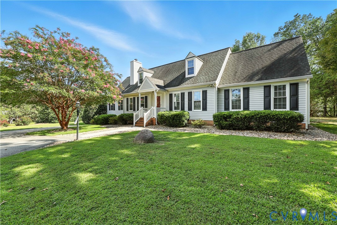 a front view of house with yard and green space