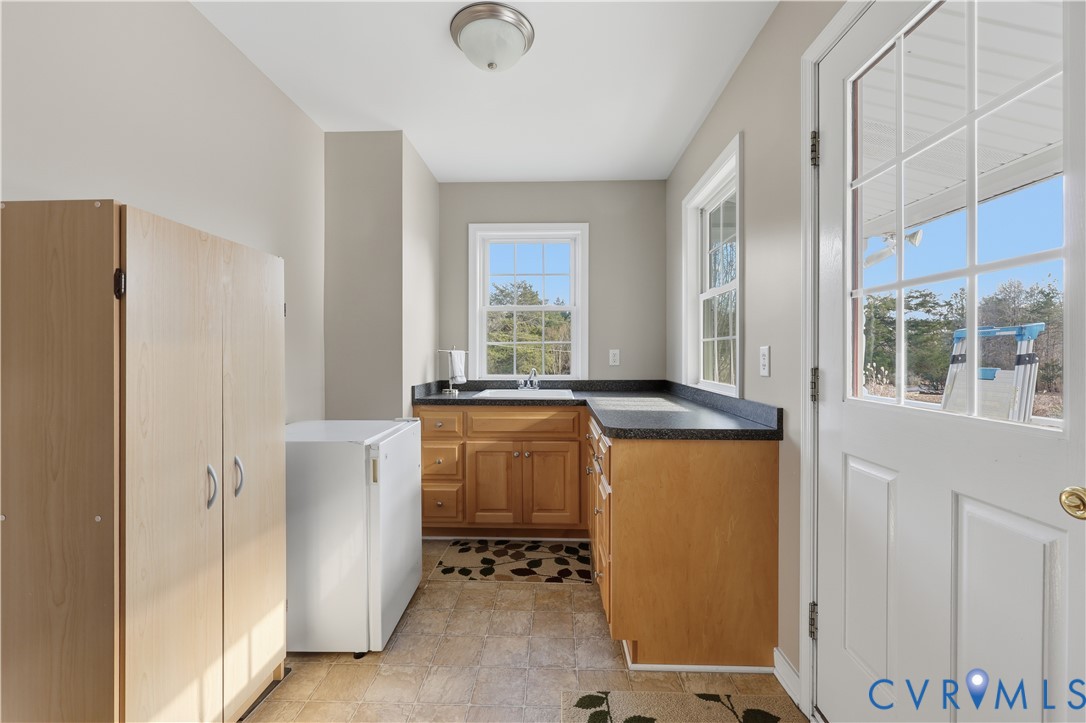 2326 Mill Road Powhatan, VA 23139 - Photo 15 of 50 a room with a refrigerator and a dresser
