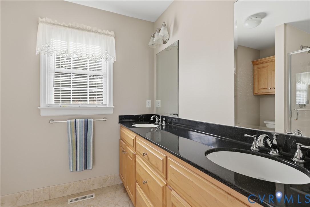 2326 Mill Road Powhatan, VA 23139 - Photo 23 of 50 a bathroom with a granite countertop sink and a mirror