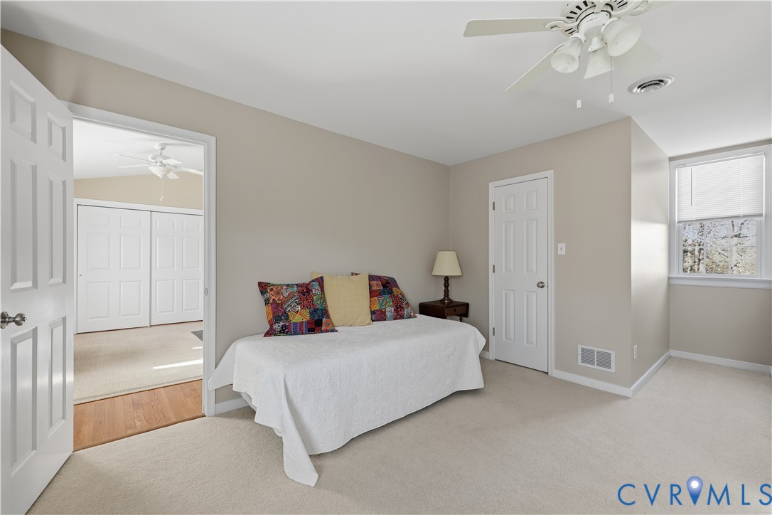 2326 Mill Road Powhatan, VA 23139 - Photo 27 of 50 a bedroom with a large bed and a chandelier