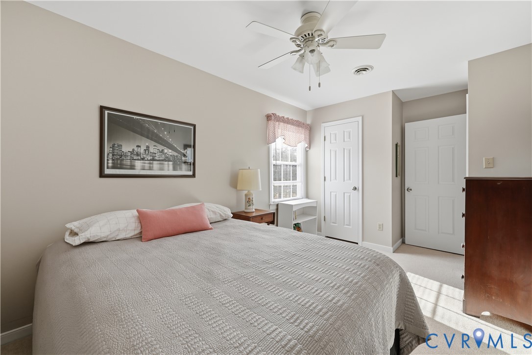 2326 Mill Road Powhatan, VA 23139 - Photo 30 of 50 a bedroom with a large bed and a chandelier