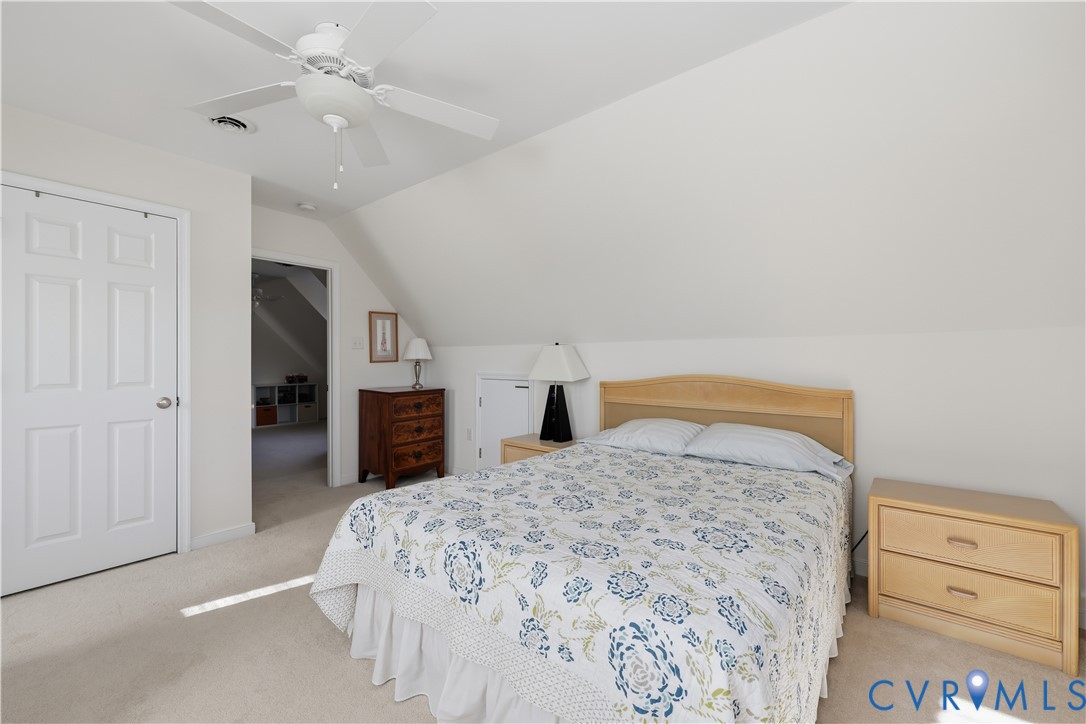 2326 Mill Road Powhatan, VA 23139 - Photo 32 of 50 a bedroom with a large bed and a chandelier