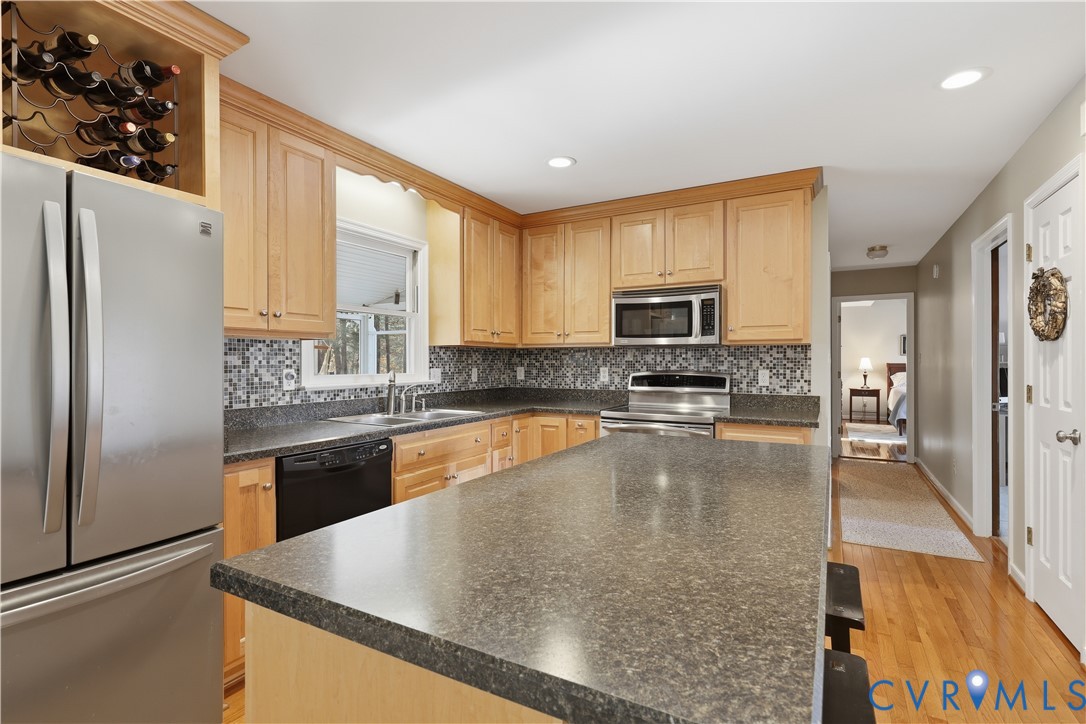 2326 Mill Road Powhatan, VA 23139 - Photo 6 of 50 a large kitchen with granite countertop a refrigerator a stove and a sink