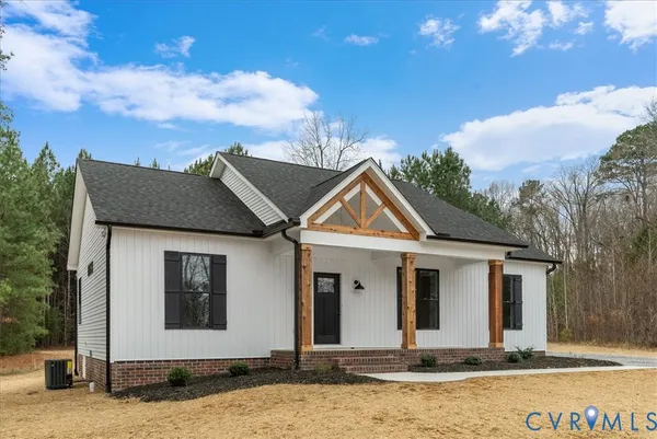 a spacious bathroom with a granite countertop sink a mirror and a shower