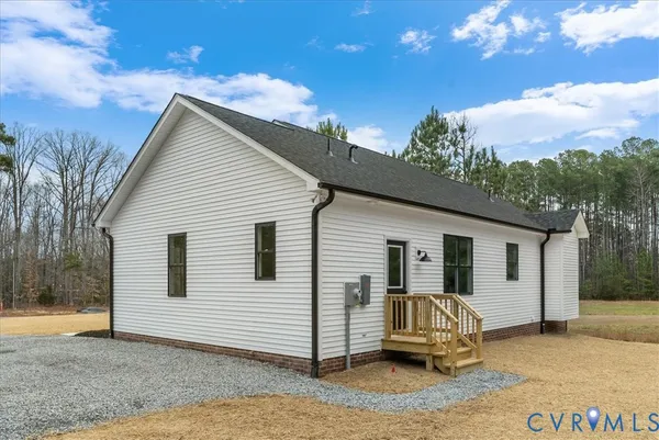 a view of a porch with furniture and floor to ceiling window