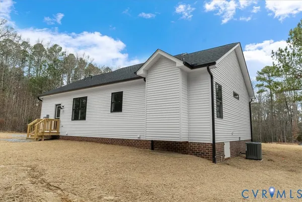 a kitchen with stainless steel appliances granite countertop a stove a sink dishwasher a refrigerator and a microwave oven with wooden floor