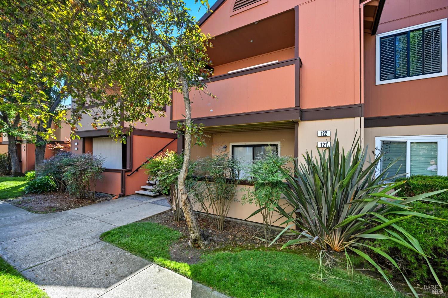 8201 Camino Colegio, Unit 122 Rohnert Park, CA 94928 - Photo 2 of 27 a front view of a house with a garden