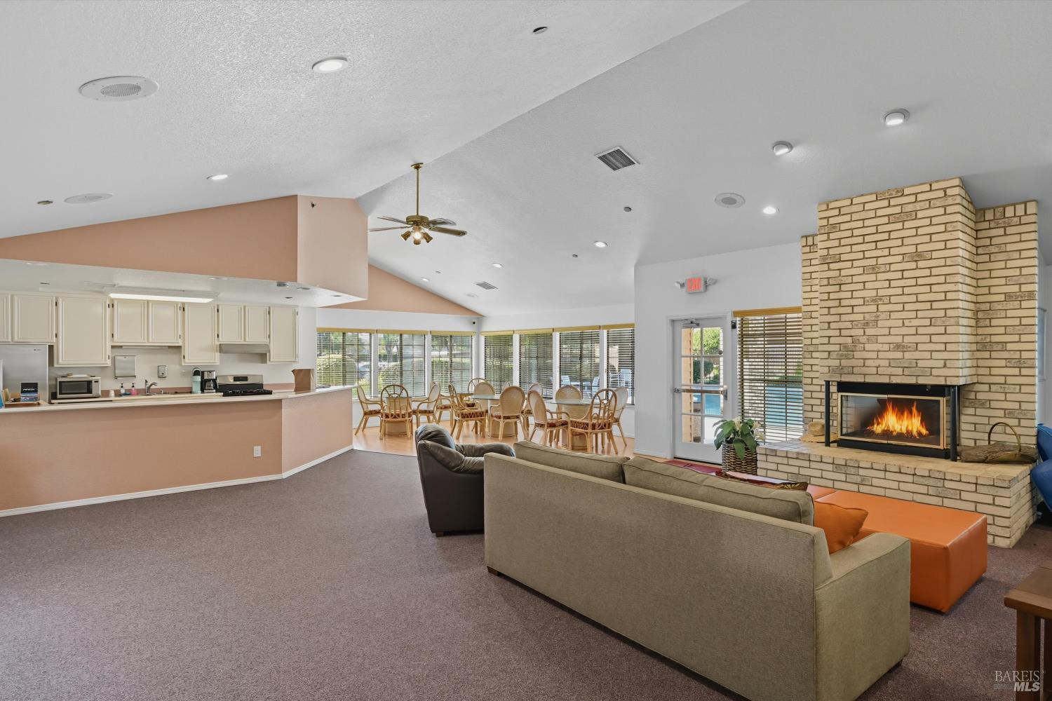 8201 Camino Colegio, Unit 122 Rohnert Park, CA 94928 - Photo 22 of 27 a living room with fireplace furniture and a large window