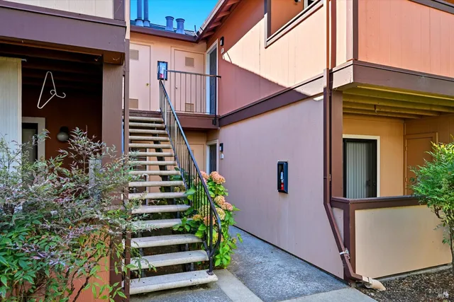 a front view of a house with plants