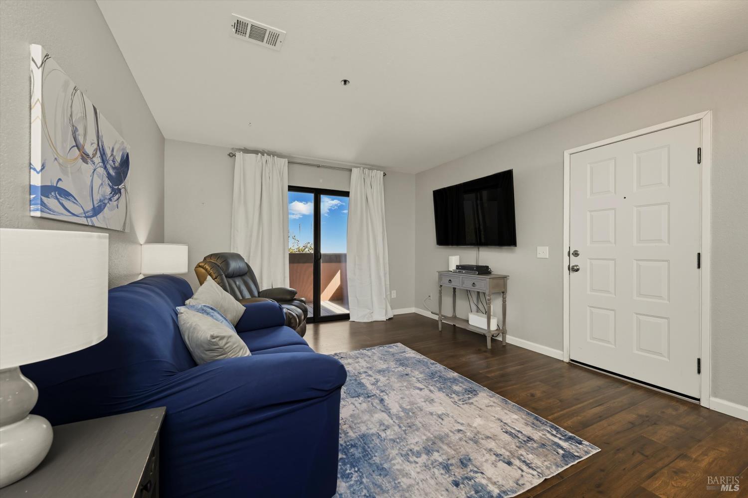 8201 Camino Colegio, Unit 122 Rohnert Park, CA 94928 - Photo 3 of 27 a living room with furniture and a flat screen tv