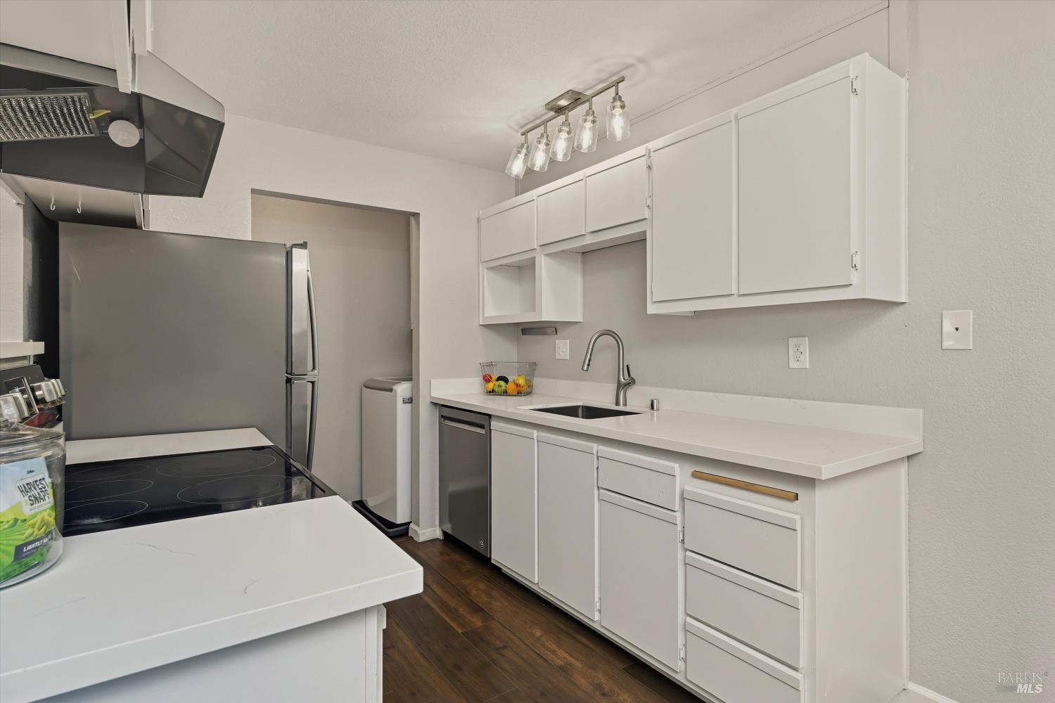 8201 Camino Colegio, Unit 122 Rohnert Park, CA 94928 - Photo 6 of 27 a kitchen with a sink a stove and white cabinets