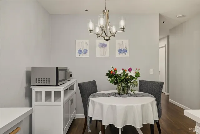 a view of a dining room with furniture and a chandelier