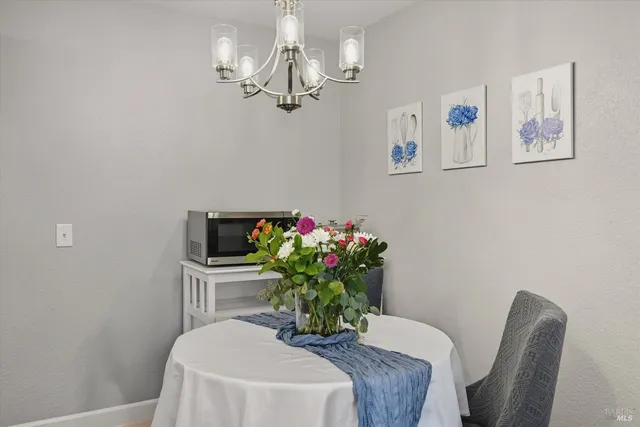 a dining room with furniture and wooden floor