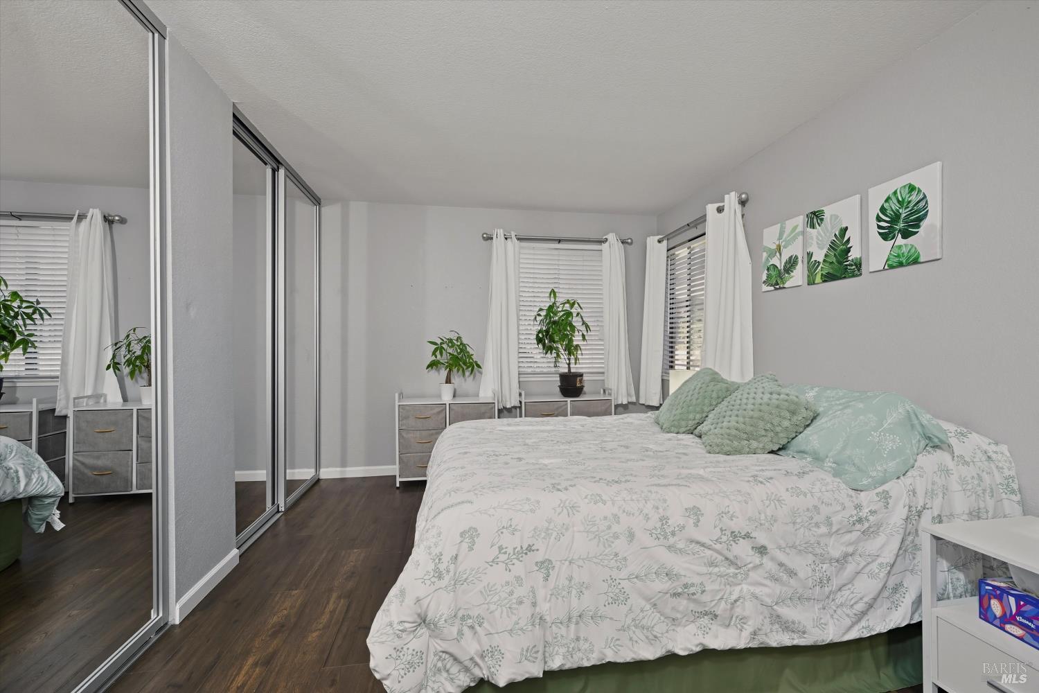 8201 Camino Colegio, Unit 122 Rohnert Park, CA 94928 - Photo 9 of 27 a bedroom with a bed potted plant with the wooden floor