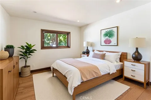 a bedroom with a bed and a potted plant