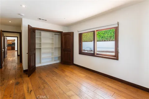 an empty room with closet and a window
