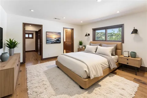 a spacious bedroom with a large bed and a large window