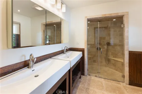 a bathroom with a shower sink and mirror