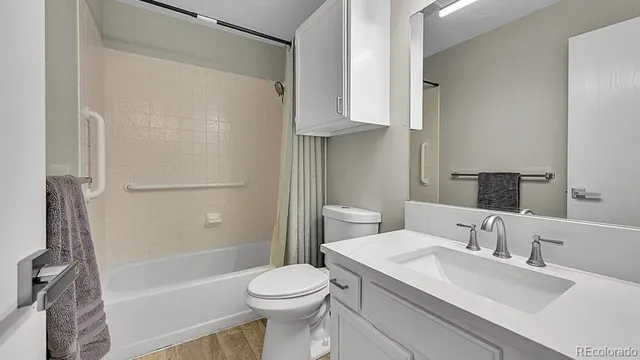 a bathroom with a sink toilet and shower