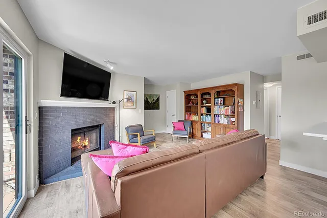 a living room with fireplace furniture and a flat screen tv